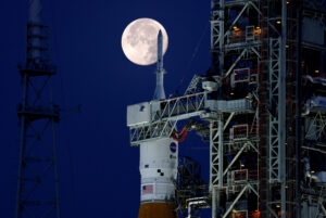 A full moon, known as the "Strawberry Moon" is shown with NASA’s next-generation moon rocket, the Space Launch System (SLS) Artemis 1, at the Kennedy Space Center in Merritt Island, Florida,  June 15, 2022. (Photo Credit: REUTERS)