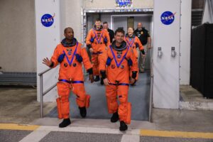 Artemis II astronauts, from left, NASA astronaut Victor Glover (left), CSA (Canadian Space Agency) astronaut Jeremy Hansen, NASA astronauts Christina Koch and Reid Wiseman stand on the crew access arm of the mobile launcher at Launch Pad 39B as part of an integrated ground systems test at Kennedy Space Center in Florida on Wednesday, September 20. (Photo Credit: NASA/Frank Michaux)